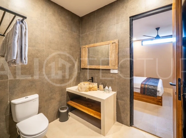 Brand-new 2-bedroom freehold villa near Pandawa Beach, featuring a modern tropical design, spacious interiors, high ceilings, large glass windows, private swimming pool, and elegant natural stone and wood finishes.