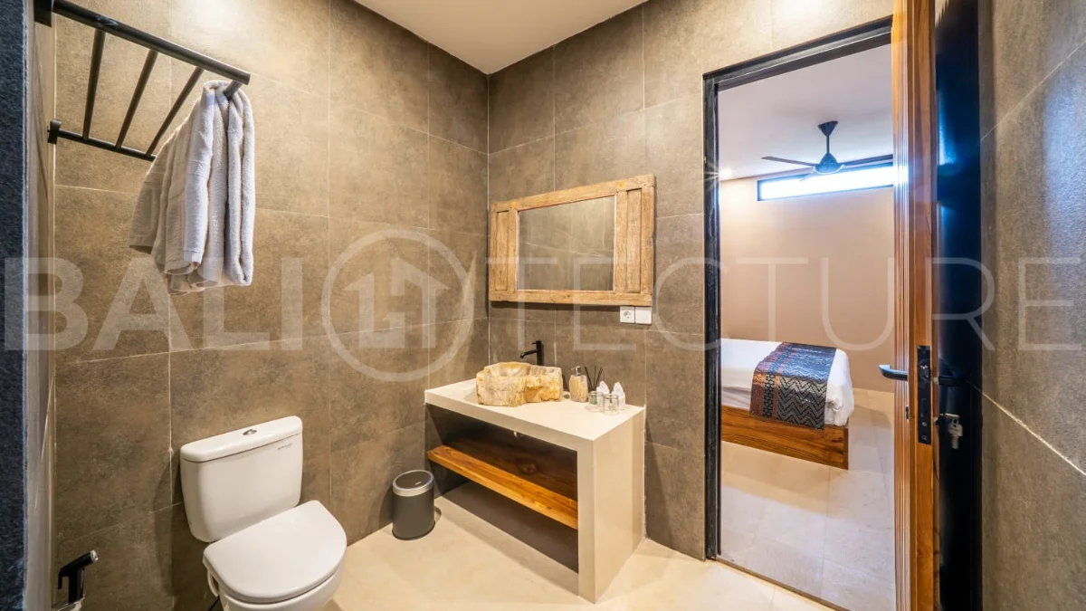Brand-new 2-bedroom freehold villa near Pandawa Beach, featuring a modern tropical design, spacious interiors, high ceilings, large glass windows, private swimming pool, and elegant natural stone and wood finishes.