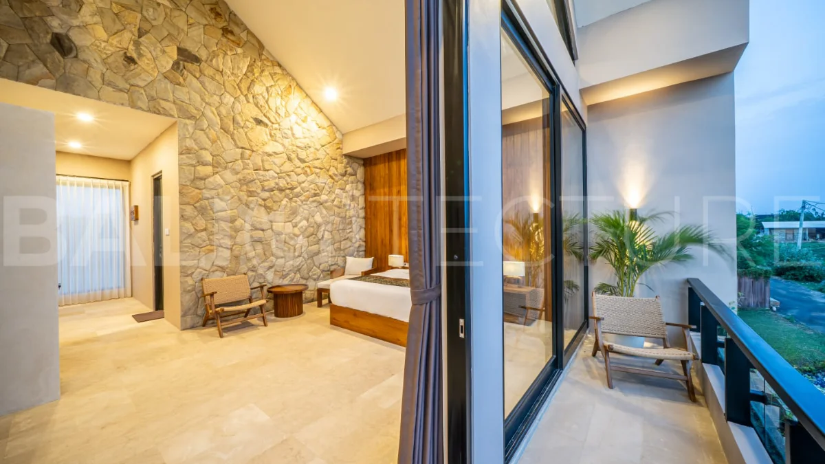 Brand-new 2-bedroom freehold villa near Pandawa Beach, featuring a modern tropical design, spacious interiors, high ceilings, large glass windows, private swimming pool, and elegant natural stone and wood finishes.