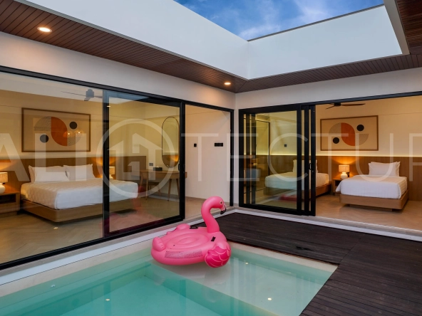 Modern 2-bedroom villa for sale in Jimbaran, Bali, featuring a contemporary open-plan design, 126 sqm of living space, two en-suite bedrooms, full furnishings, premium community facilities, and a 100-year leasehold option.