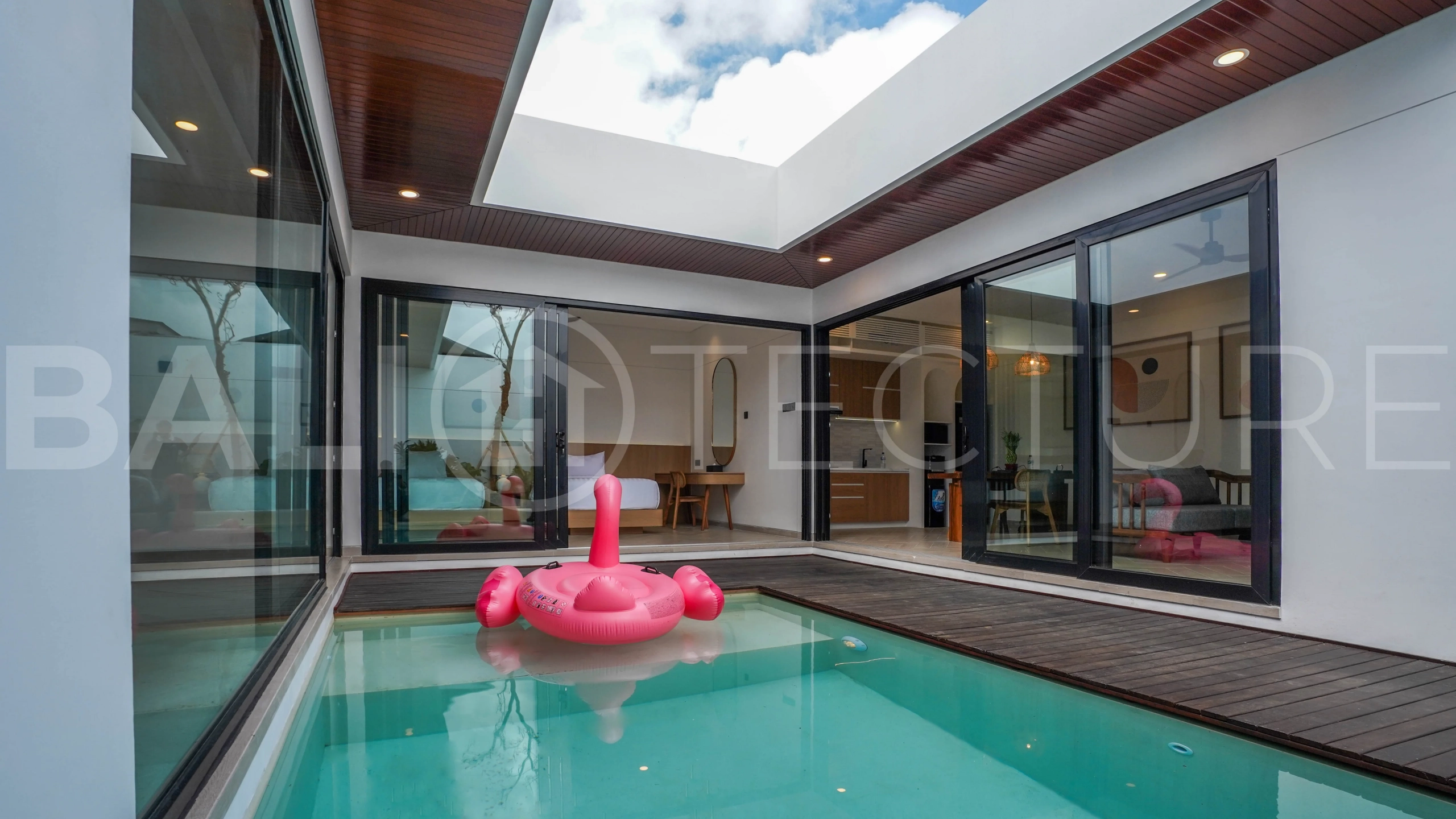 Modern 2-bedroom villa for sale in Jimbaran, Bali, featuring a contemporary open-plan design, 126 sqm of living space, two en-suite bedrooms, full furnishings, premium community facilities, and a 100-year leasehold option.
