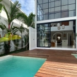 Modern 1-bedroom villa for sale in Balangan featuring a private swimming pool, tropical garden, wooden pool deck, minimalist interiors, and a peaceful residential setting near Balangan Beach.