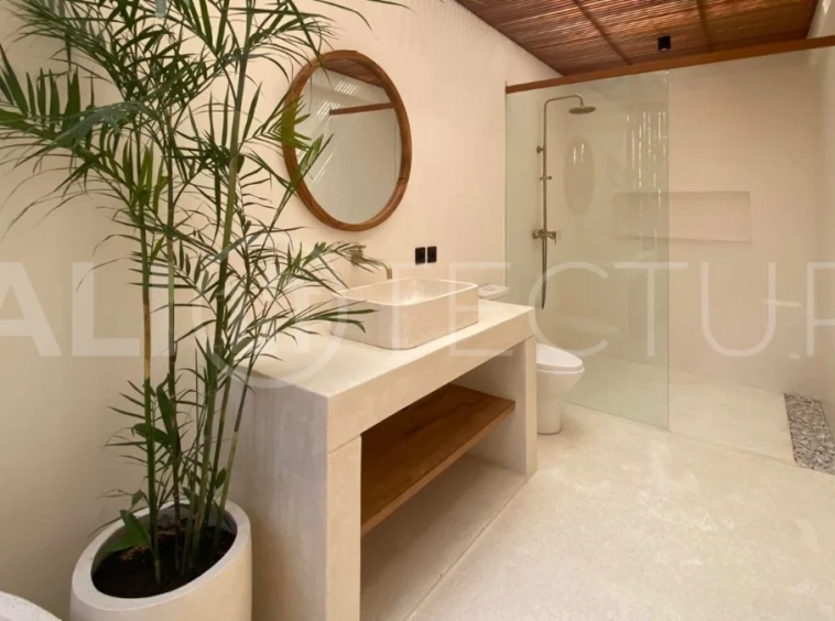 Modern 1-bedroom villa for sale in Balangan featuring a private swimming pool, tropical garden, wooden pool deck, minimalist interiors, and a peaceful residential setting near Balangan Beach.