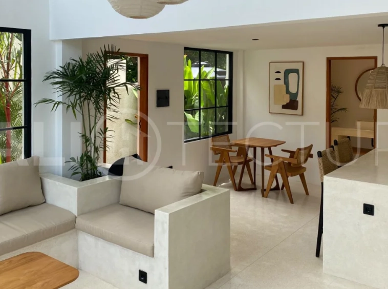 Modern 1-bedroom villa for sale in Balangan featuring a private swimming pool, tropical garden, wooden pool deck, minimalist interiors, and a peaceful residential setting near Balangan Beach.