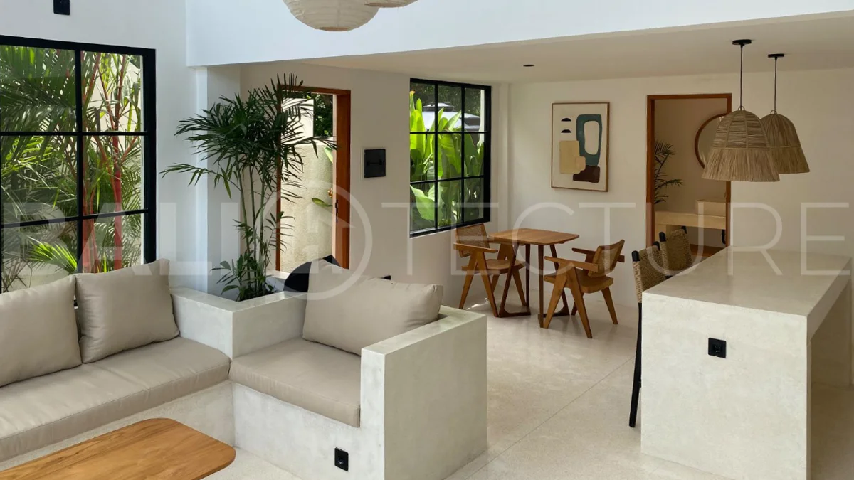 Modern 1-bedroom villa for sale in Balangan featuring a private swimming pool, tropical garden, wooden pool deck, minimalist interiors, and a peaceful residential setting near Balangan Beach.