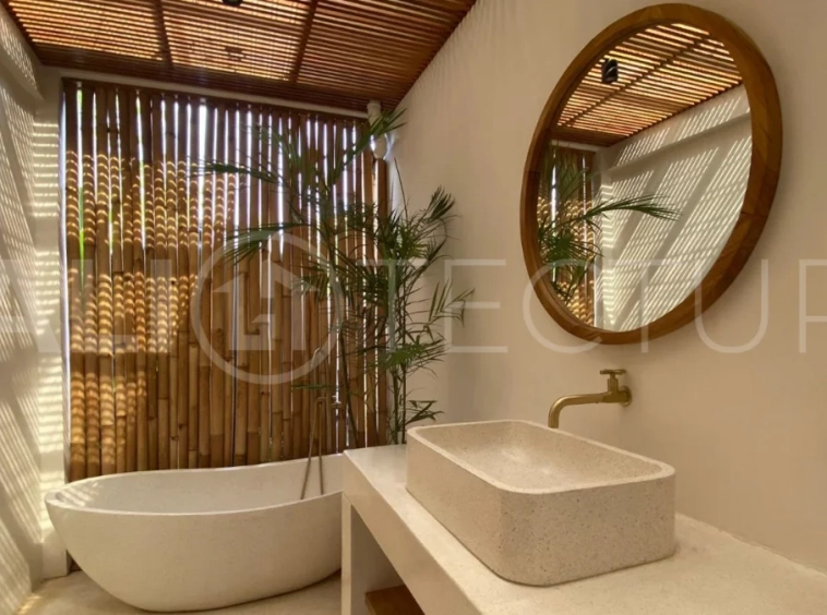 Modern 1-bedroom villa for sale in Balangan featuring a private swimming pool, tropical garden, wooden pool deck, minimalist interiors, and a peaceful residential setting near Balangan Beach.