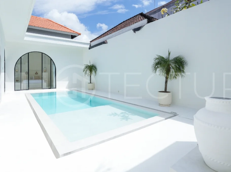 Newly built modern minimalist 2-bedroom villa in Padonan, Canggu, featuring a private swimming pool, tropical landscaping, enclosed living areas, and a contemporary tropical design.