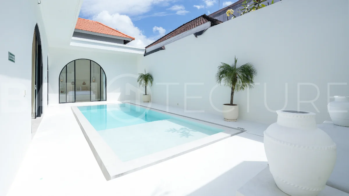 Newly built modern minimalist 2-bedroom villa in Padonan, Canggu, featuring a private swimming pool, tropical landscaping, enclosed living areas, and a contemporary tropical design.