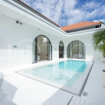 Newly built modern minimalist 2-bedroom villa in Padonan, Canggu, featuring a private swimming pool, tropical landscaping, enclosed living areas, and a contemporary tropical design.