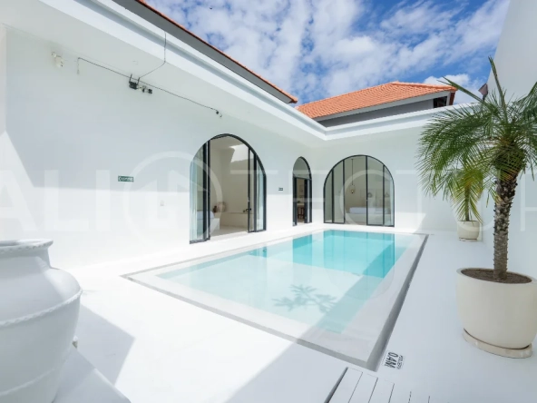 Newly built modern minimalist 2-bedroom villa in Padonan, Canggu, featuring a private swimming pool, tropical landscaping, enclosed living areas, and a contemporary tropical design.
