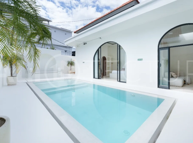 Newly built modern minimalist 2-bedroom villa in Padonan, Canggu, featuring a private swimming pool, tropical landscaping, enclosed living areas, and a contemporary tropical design.
