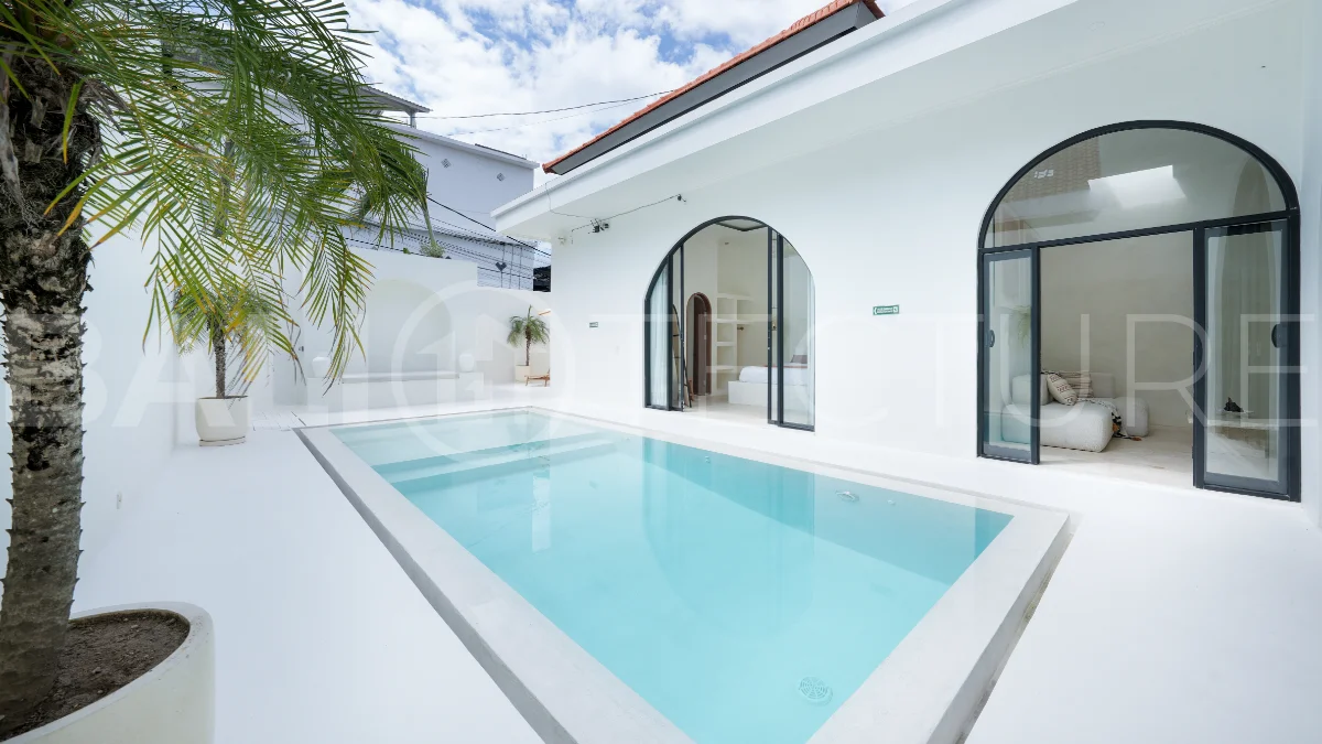 Newly built modern minimalist 2-bedroom villa in Padonan, Canggu, featuring a private swimming pool, tropical landscaping, enclosed living areas, and a contemporary tropical design.