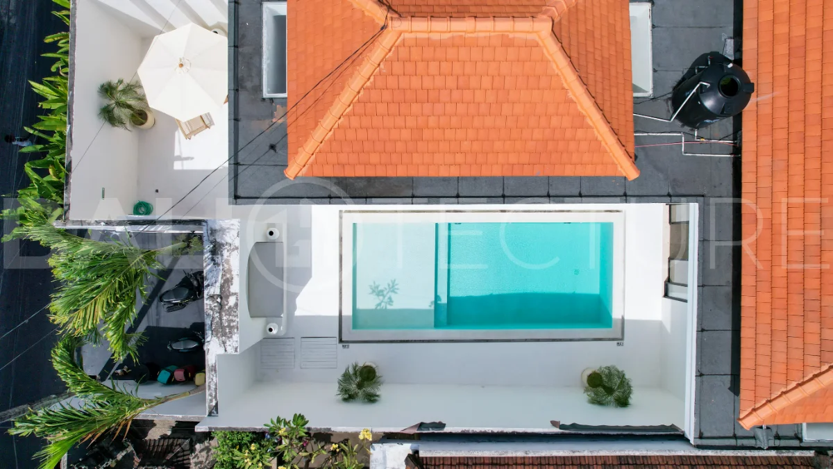 Newly built modern minimalist 2-bedroom villa in Padonan, Canggu, featuring a private swimming pool, tropical landscaping, enclosed living areas, and a contemporary tropical design.