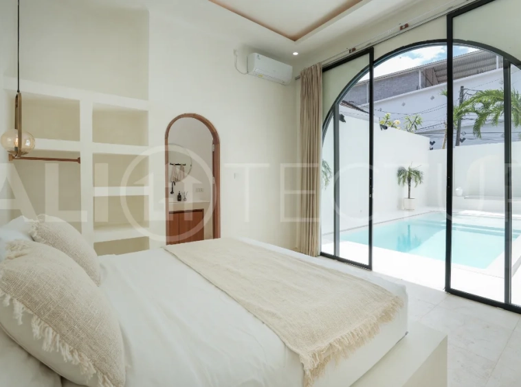 Newly built modern minimalist 2-bedroom villa in Padonan, Canggu, featuring a private swimming pool, tropical landscaping, enclosed living areas, and a contemporary tropical design.