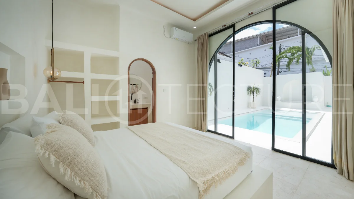 Newly built modern minimalist 2-bedroom villa in Padonan, Canggu, featuring a private swimming pool, tropical landscaping, enclosed living areas, and a contemporary tropical design.