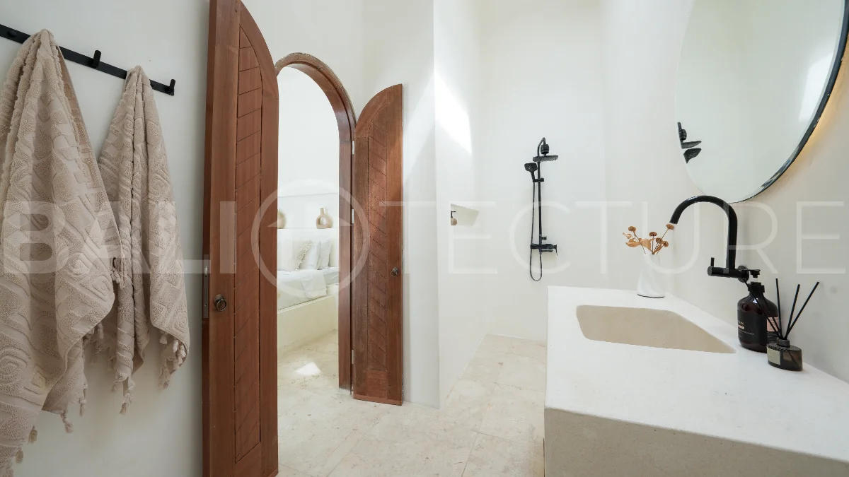 Newly built modern minimalist 2-bedroom villa in Padonan, Canggu, featuring a private swimming pool, tropical landscaping, enclosed living areas, and a contemporary tropical design.