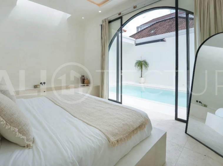 Newly built modern minimalist 2-bedroom villa in Padonan, Canggu, featuring a private swimming pool, tropical landscaping, enclosed living areas, and a contemporary tropical design.