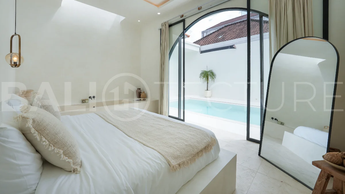 Newly built modern minimalist 2-bedroom villa in Padonan, Canggu, featuring a private swimming pool, tropical landscaping, enclosed living areas, and a contemporary tropical design.