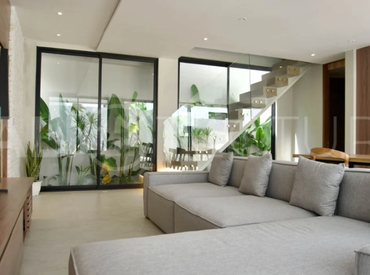 Modern 2 Bedroom Villa for Sale in Ungasan featuring contemporary Mediterranean and industrial inspired architecture, enclosed living and dining areas, a fully equipped kitchen with island, two ensuite bedrooms with private balconies, a private swimming pool, landscaped garden, and covered parking. Situated on 180 sqm of land with a 27 year leasehold, just minutes from Melasti Beach, New Kuta Golf, Savaya, and Bingin.
