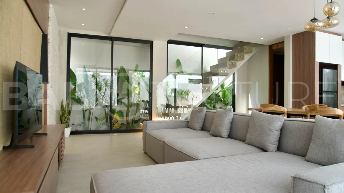 Modern 2 Bedroom Villa for Sale in Ungasan featuring contemporary Mediterranean and industrial inspired architecture, enclosed living and dining areas, a fully equipped kitchen with island, two ensuite bedrooms with private balconies, a private swimming pool, landscaped garden, and covered parking. Situated on 180 sqm of land with a 27 year leasehold, just minutes from Melasti Beach, New Kuta Golf, Savaya, and Bingin.