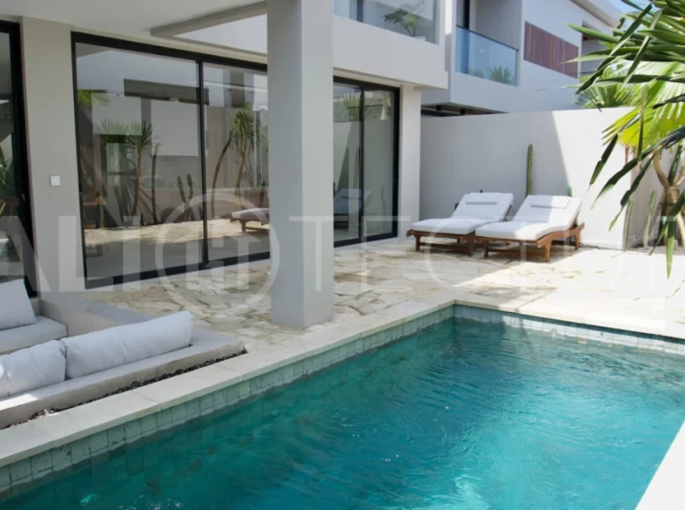 Modern 2 Bedroom Villa for Sale in Ungasan featuring contemporary Mediterranean and industrial inspired architecture, enclosed living and dining areas, a fully equipped kitchen with island, two ensuite bedrooms with private balconies, a private swimming pool, landscaped garden, and covered parking. Situated on 180 sqm of land with a 27 year leasehold, just minutes from Melasti Beach, New Kuta Golf, Savaya, and Bingin.