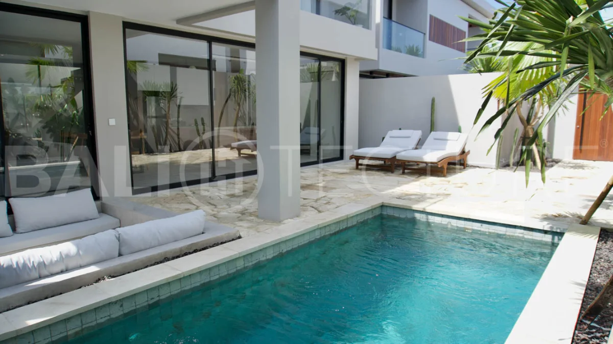 Modern 2 Bedroom Villa for Sale in Ungasan featuring contemporary Mediterranean and industrial inspired architecture, enclosed living and dining areas, a fully equipped kitchen with island, two ensuite bedrooms with private balconies, a private swimming pool, landscaped garden, and covered parking. Situated on 180 sqm of land with a 27 year leasehold, just minutes from Melasti Beach, New Kuta Golf, Savaya, and Bingin.