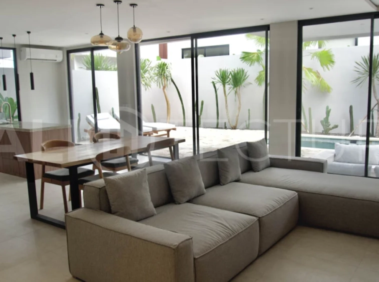 Modern 2 Bedroom Villa for Sale in Ungasan featuring contemporary Mediterranean and industrial inspired architecture, enclosed living and dining areas, a fully equipped kitchen with island, two ensuite bedrooms with private balconies, a private swimming pool, landscaped garden, and covered parking. Situated on 180 sqm of land with a 27 year leasehold, just minutes from Melasti Beach, New Kuta Golf, Savaya, and Bingin.