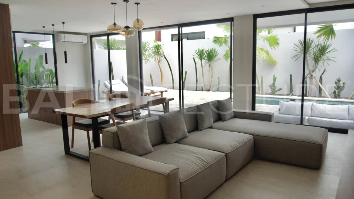 Modern 2 Bedroom Villa for Sale in Ungasan featuring contemporary Mediterranean and industrial inspired architecture, enclosed living and dining areas, a fully equipped kitchen with island, two ensuite bedrooms with private balconies, a private swimming pool, landscaped garden, and covered parking. Situated on 180 sqm of land with a 27 year leasehold, just minutes from Melasti Beach, New Kuta Golf, Savaya, and Bingin.