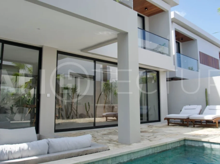 Modern 2 Bedroom Villa for Sale in Ungasan featuring contemporary Mediterranean and industrial inspired architecture, enclosed living and dining areas, a fully equipped kitchen with island, two ensuite bedrooms with private balconies, a private swimming pool, landscaped garden, and covered parking. Situated on 180 sqm of land with a 27 year leasehold, just minutes from Melasti Beach, New Kuta Golf, Savaya, and Bingin.