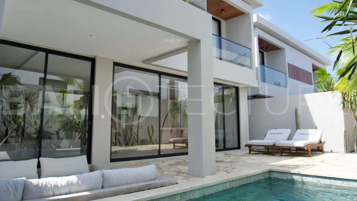 Modern 2 Bedroom Villa for Sale in Ungasan featuring contemporary Mediterranean and industrial inspired architecture, enclosed living and dining areas, a fully equipped kitchen with island, two ensuite bedrooms with private balconies, a private swimming pool, landscaped garden, and covered parking. Situated on 180 sqm of land with a 27 year leasehold, just minutes from Melasti Beach, New Kuta Golf, Savaya, and Bingin.
