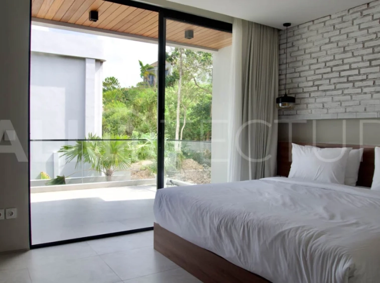 Modern 2 Bedroom Villa for Sale in Ungasan featuring contemporary Mediterranean and industrial inspired architecture, enclosed living and dining areas, a fully equipped kitchen with island, two ensuite bedrooms with private balconies, a private swimming pool, landscaped garden, and covered parking. Situated on 180 sqm of land with a 27 year leasehold, just minutes from Melasti Beach, New Kuta Golf, Savaya, and Bingin.