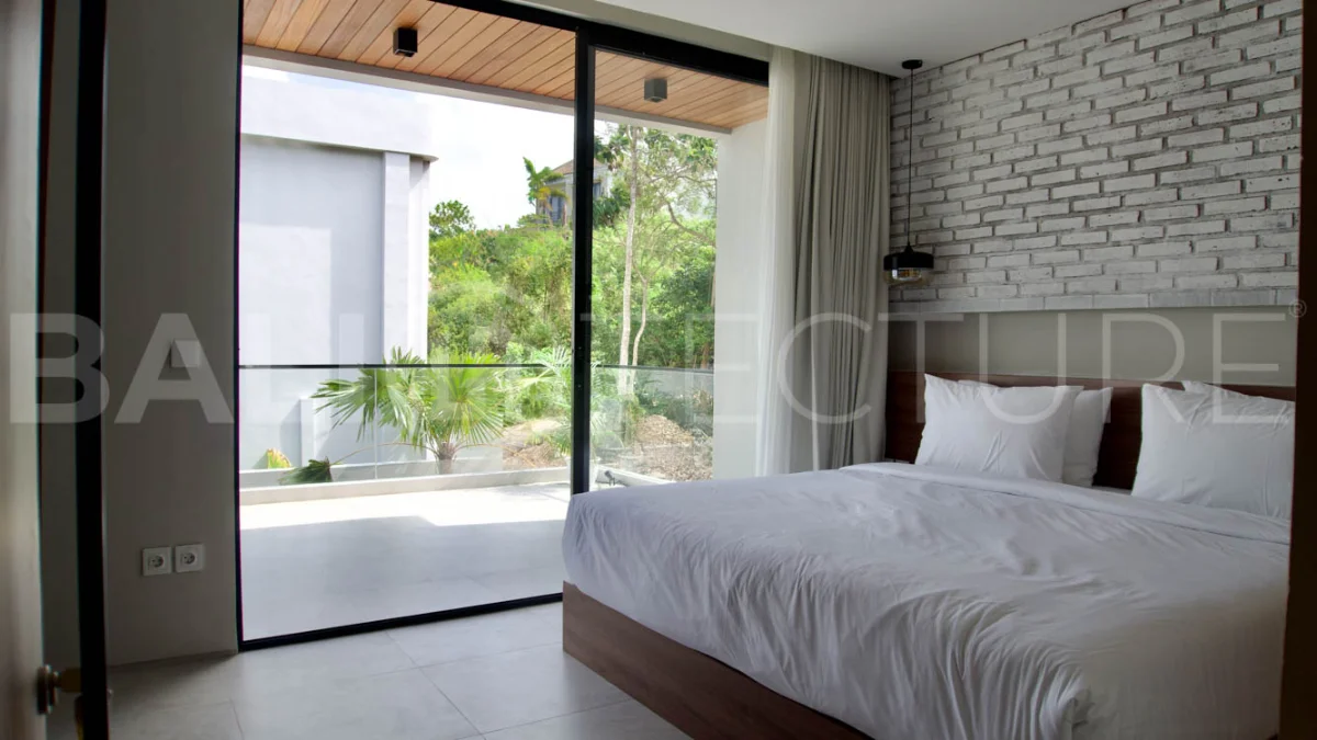 Modern 2 Bedroom Villa for Sale in Ungasan featuring contemporary Mediterranean and industrial inspired architecture, enclosed living and dining areas, a fully equipped kitchen with island, two ensuite bedrooms with private balconies, a private swimming pool, landscaped garden, and covered parking. Situated on 180 sqm of land with a 27 year leasehold, just minutes from Melasti Beach, New Kuta Golf, Savaya, and Bingin.