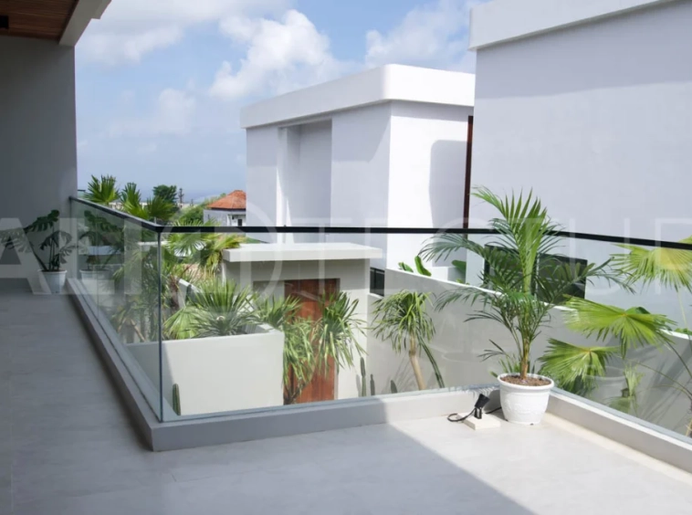 Modern 2 Bedroom Villa for Sale in Ungasan featuring contemporary Mediterranean and industrial inspired architecture, enclosed living and dining areas, a fully equipped kitchen with island, two ensuite bedrooms with private balconies, a private swimming pool, landscaped garden, and covered parking. Situated on 180 sqm of land with a 27 year leasehold, just minutes from Melasti Beach, New Kuta Golf, Savaya, and Bingin.