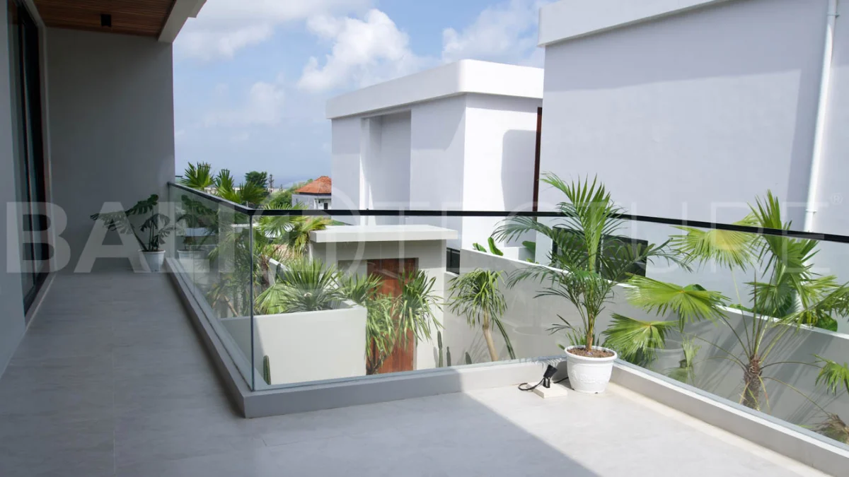 Modern 2 Bedroom Villa for Sale in Ungasan featuring contemporary Mediterranean and industrial inspired architecture, enclosed living and dining areas, a fully equipped kitchen with island, two ensuite bedrooms with private balconies, a private swimming pool, landscaped garden, and covered parking. Situated on 180 sqm of land with a 27 year leasehold, just minutes from Melasti Beach, New Kuta Golf, Savaya, and Bingin.