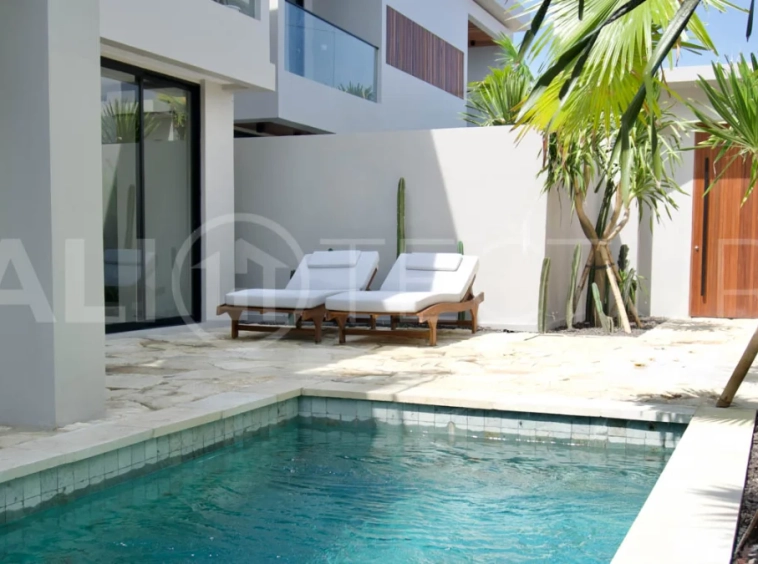 Modern 2 Bedroom Villa for Sale in Ungasan featuring contemporary Mediterranean and industrial inspired architecture, enclosed living and dining areas, a fully equipped kitchen with island, two ensuite bedrooms with private balconies, a private swimming pool, landscaped garden, and covered parking. Situated on 180 sqm of land with a 27 year leasehold, just minutes from Melasti Beach, New Kuta Golf, Savaya, and Bingin.