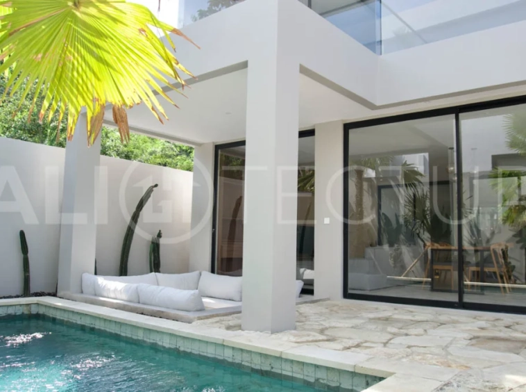 Modern 2 Bedroom Villa for Sale in Ungasan featuring contemporary Mediterranean and industrial inspired architecture, enclosed living and dining areas, a fully equipped kitchen with island, two ensuite bedrooms with private balconies, a private swimming pool, landscaped garden, and covered parking. Situated on 180 sqm of land with a 27 year leasehold, just minutes from Melasti Beach, New Kuta Golf, Savaya, and Bingin.