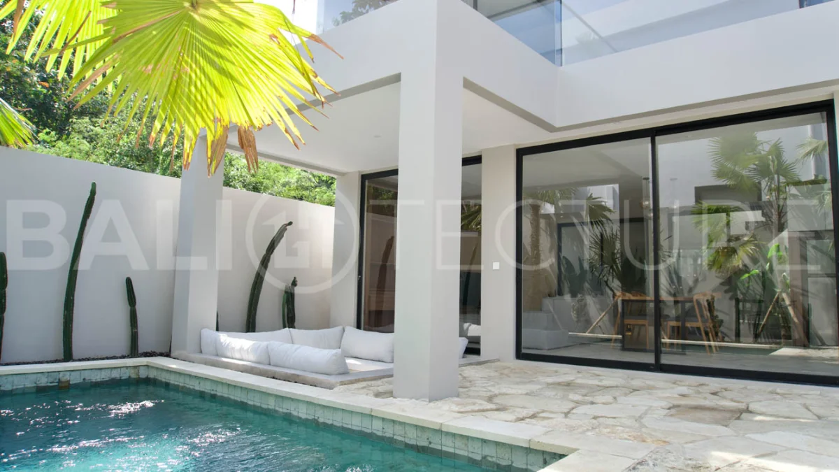 Modern 2 Bedroom Villa for Sale in Ungasan featuring contemporary Mediterranean and industrial inspired architecture, enclosed living and dining areas, a fully equipped kitchen with island, two ensuite bedrooms with private balconies, a private swimming pool, landscaped garden, and covered parking. Situated on 180 sqm of land with a 27 year leasehold, just minutes from Melasti Beach, New Kuta Golf, Savaya, and Bingin.