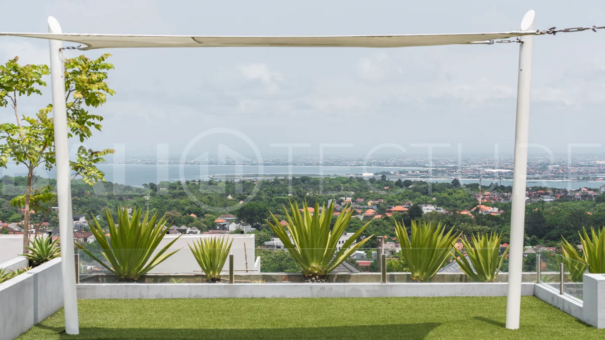 Luxury 4-bedroom turnkey villa for sale in Ungasan, Bali, featuring a private pool, elegant tropical interiors, home cinema, and a 360° panoramic rooftop with ocean, GWK, and Mount Agung views.