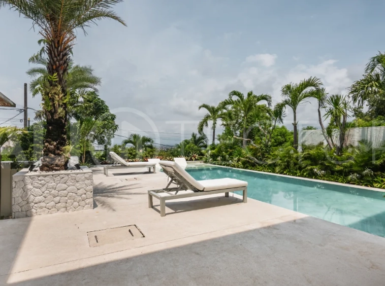 Luxury 4-bedroom turnkey villa for sale in Ungasan, Bali, featuring a private pool, elegant tropical interiors, home cinema, and a 360° panoramic rooftop with ocean, GWK, and Mount Agung views.