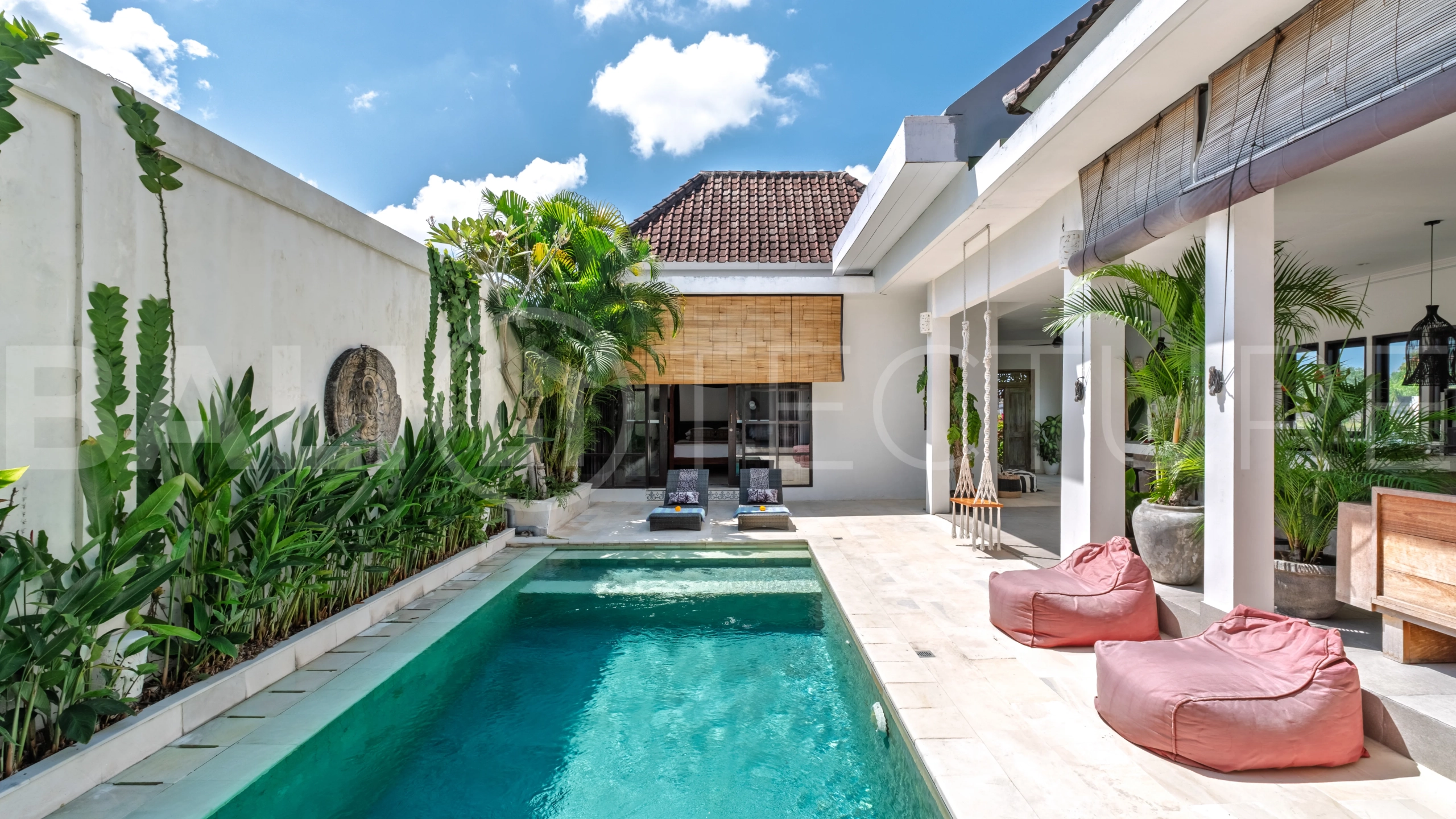 3-bedroom ricefield view villa for sale in Seminyak, featuring a private swimming pool, tropical garden, spacious living areas, and a peaceful residential setting.