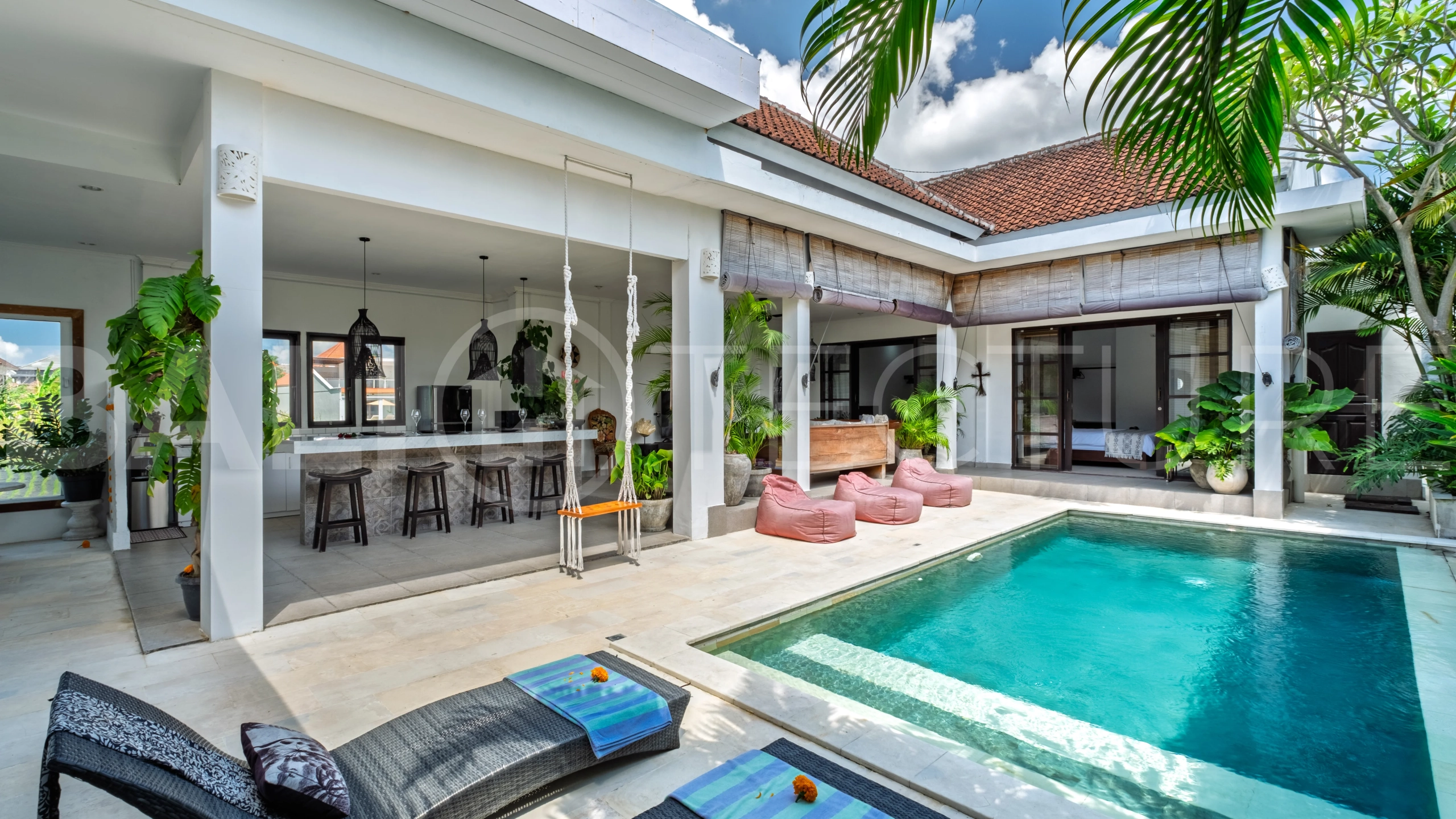 3-bedroom ricefield view villa for sale in Seminyak, featuring a private swimming pool, tropical garden, spacious living areas, and a peaceful residential setting.