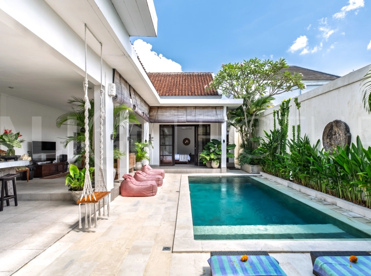 3-bedroom ricefield view villa for sale in Seminyak, featuring a private swimming pool, tropical garden, spacious living areas, and a peaceful residential setting.