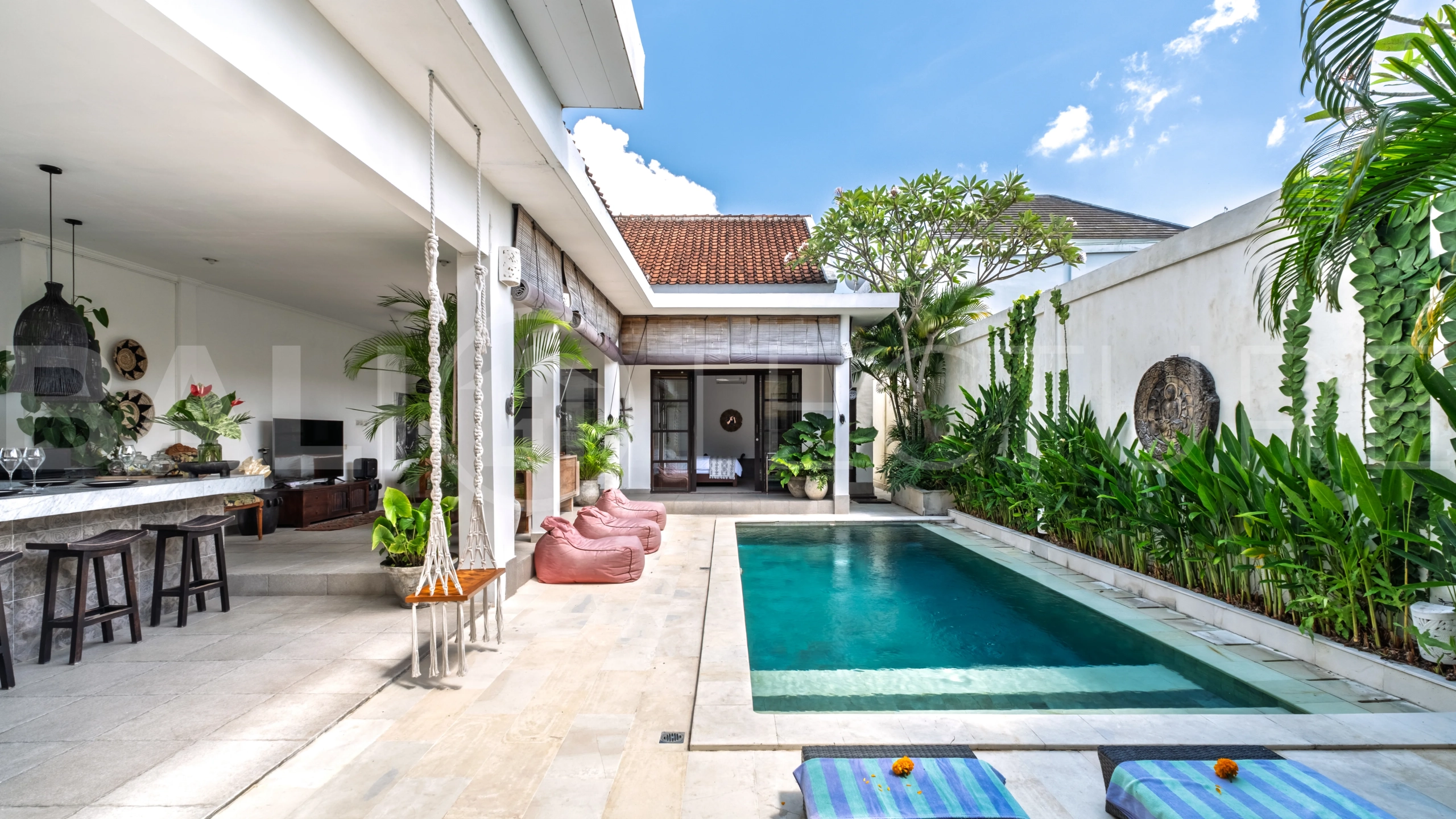3-bedroom ricefield view villa for sale in Seminyak, featuring a private swimming pool, tropical garden, spacious living areas, and a peaceful residential setting.