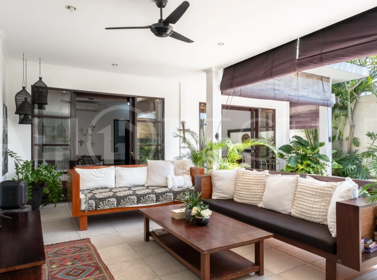 3-bedroom ricefield view villa for sale in Seminyak, featuring a private swimming pool, tropical garden, spacious living areas, and a peaceful residential setting.