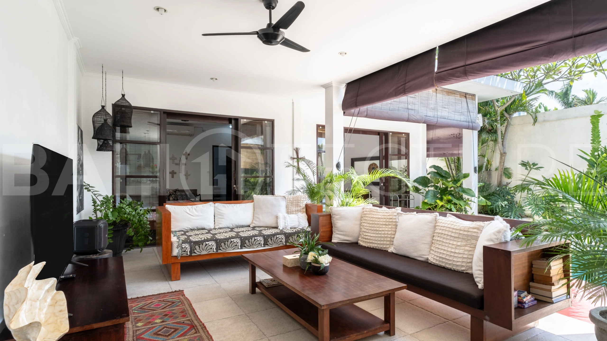 3-bedroom ricefield view villa for sale in Seminyak, featuring a private swimming pool, tropical garden, spacious living areas, and a peaceful residential setting.