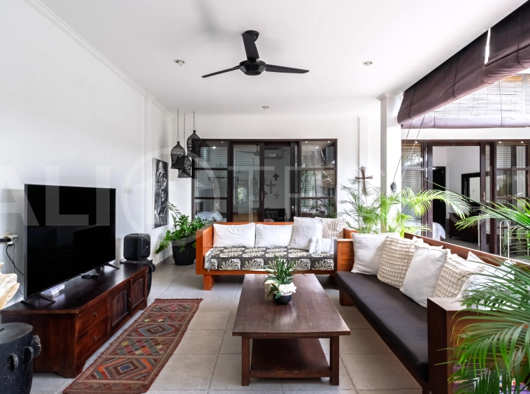 3-bedroom ricefield view villa for sale in Seminyak, featuring a private swimming pool, tropical garden, spacious living areas, and a peaceful residential setting.