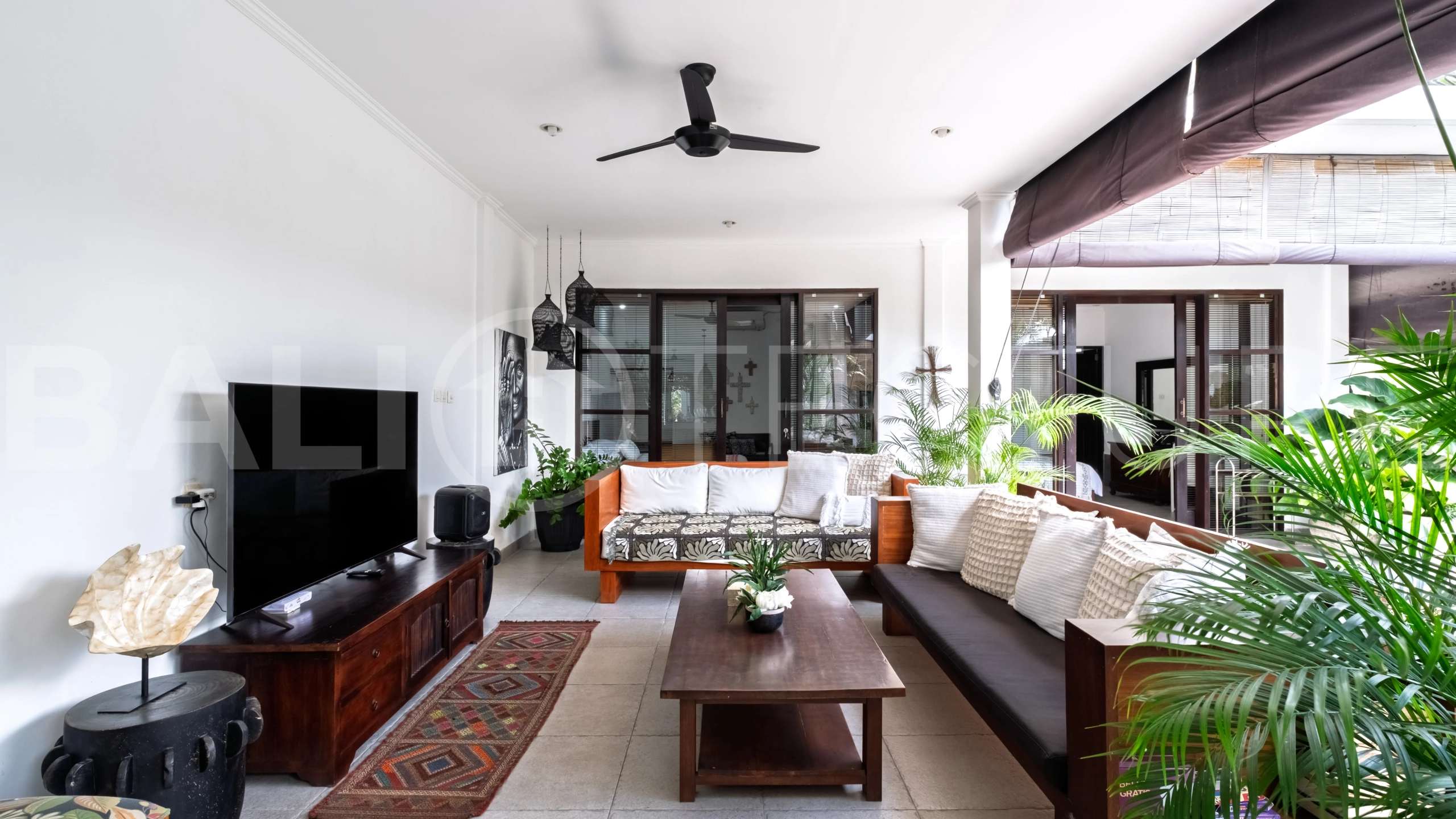 3-bedroom ricefield view villa for sale in Seminyak, featuring a private swimming pool, tropical garden, spacious living areas, and a peaceful residential setting.