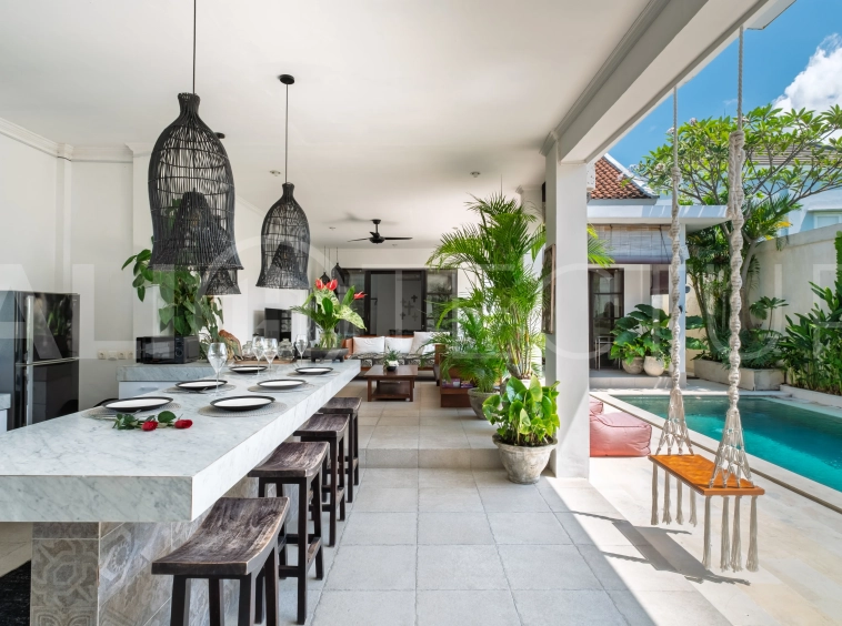 3-bedroom ricefield view villa for sale in Seminyak, featuring a private swimming pool, tropical garden, spacious living areas, and a peaceful residential setting.