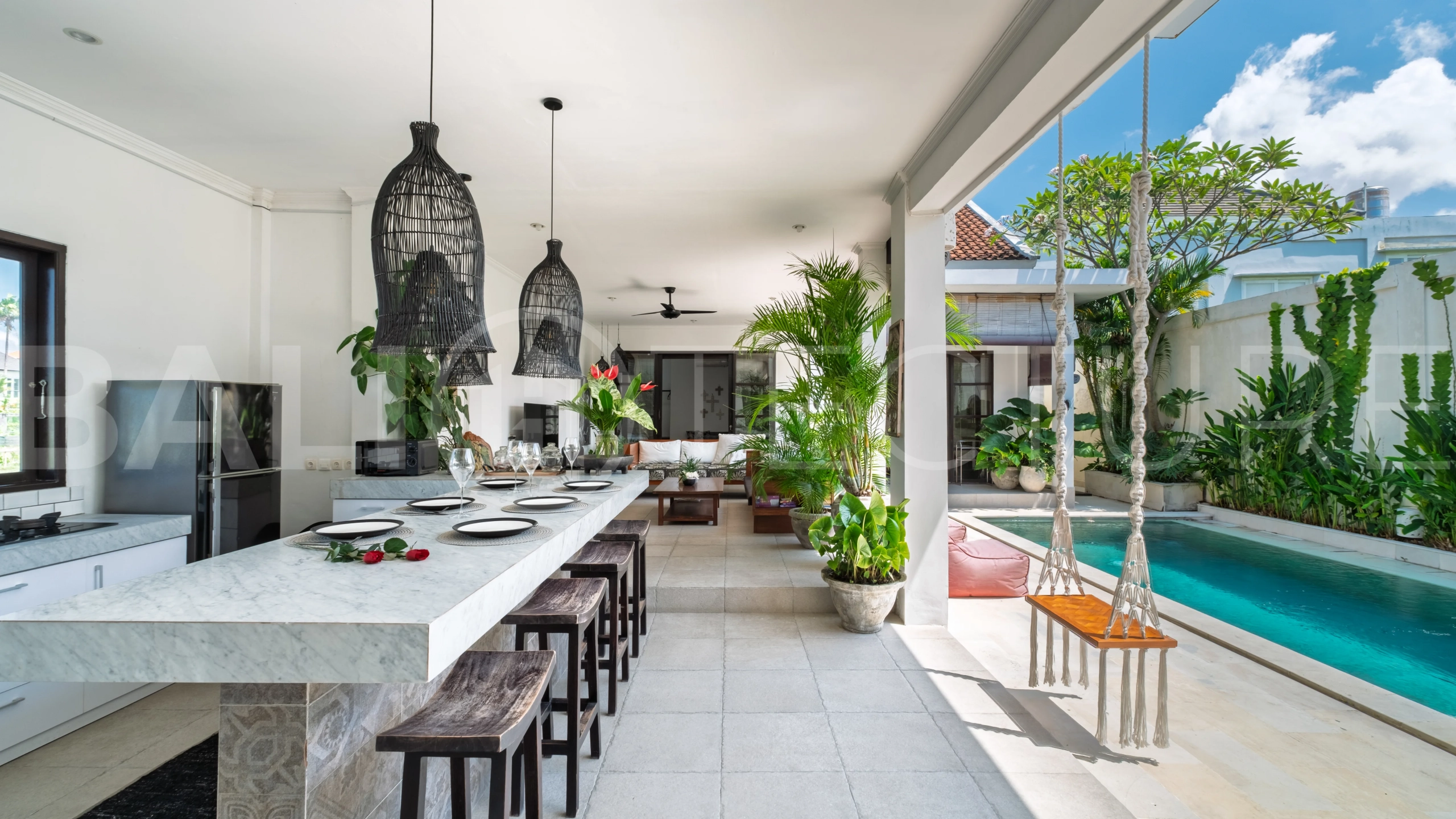 3-bedroom ricefield view villa for sale in Seminyak, featuring a private swimming pool, tropical garden, spacious living areas, and a peaceful residential setting.