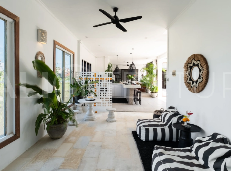 3-bedroom ricefield view villa for sale in Seminyak, featuring a private swimming pool, tropical garden, spacious living areas, and a peaceful residential setting.